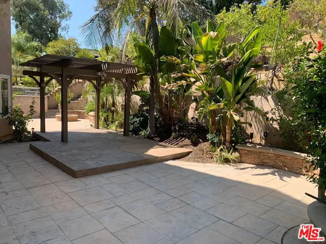 a view of porch with a table and chairs under an umbrella