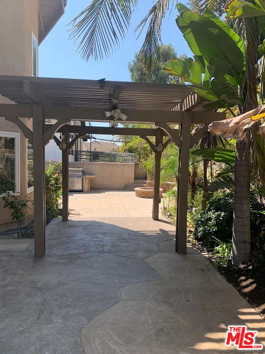 19219 Dunure Place Porter Ranch, CA 91326 - Photo 24 of 30 a view of porch with a table and chairs under an umbrella