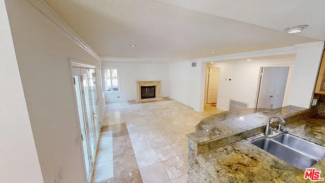 a spacious bathroom with a granite countertop sink and a mirror