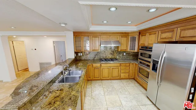 a large kitchen with a large window in it and kitchen island