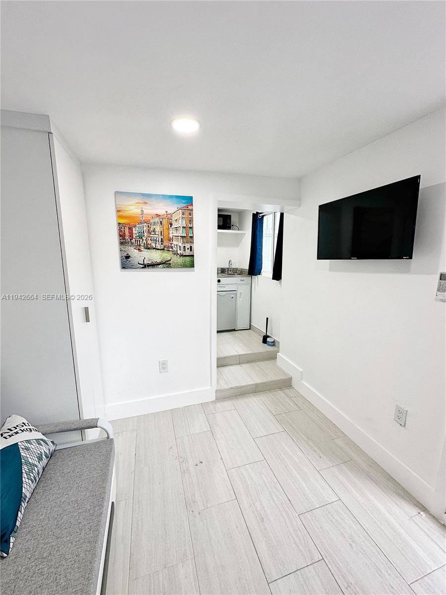 2400 Northwest 9th Street, Unit 3 Miami, FL 33125 - Photo 4 of 10 a view of a livingroom with furniture and a flat screen tv