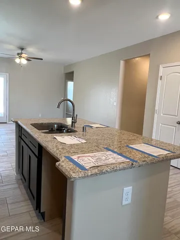 a bathroom with a granite countertop sink a toilet and mirror