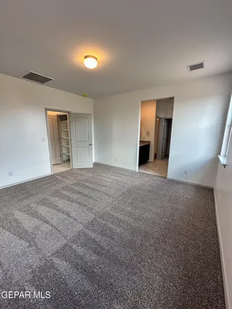 a view of a big room with closet and mirror