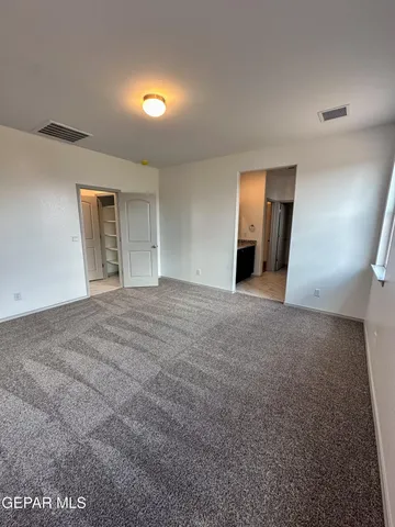 a view of a big room with closet and mirror