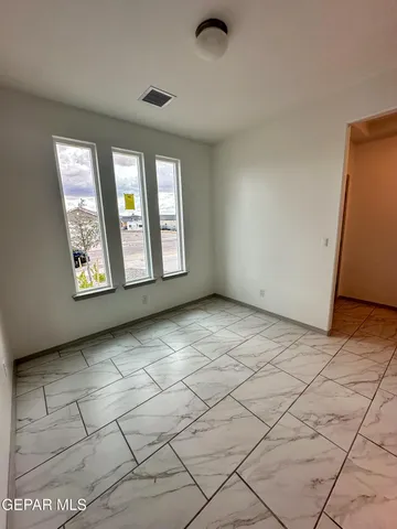 a large white kitchen with kitchen island granite countertop a stove a sink and a microwave