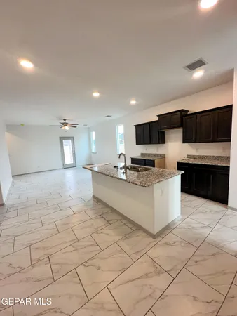 a bathroom with a granite countertop bathtub and sink