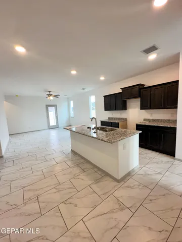 a bathroom with a granite countertop bathtub and sink