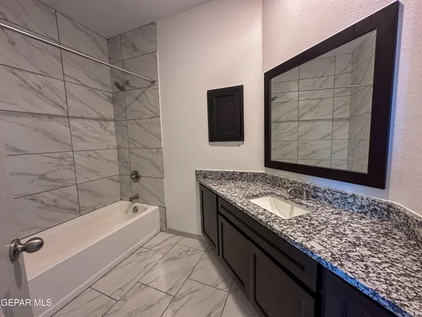 an empty room with closet and windows