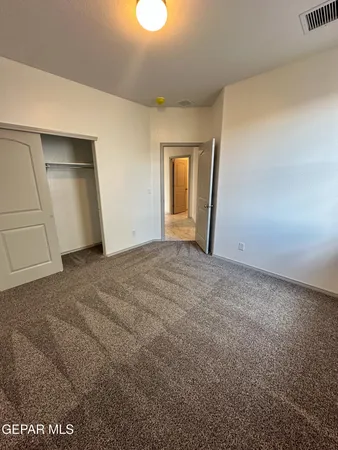 a view of an empty room and closet