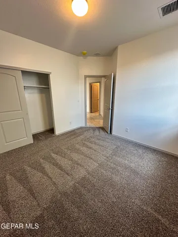 a view of an empty room and closet