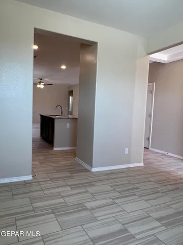 a view of a kitchen with a sink and a refrigerator