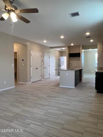 a view of a kitchen with a sink and a ceiling fan