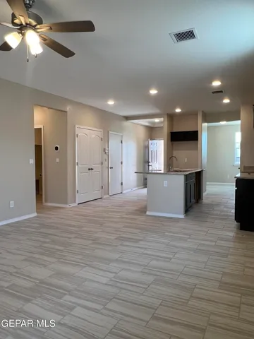 a view of a kitchen with a sink and a ceiling fan