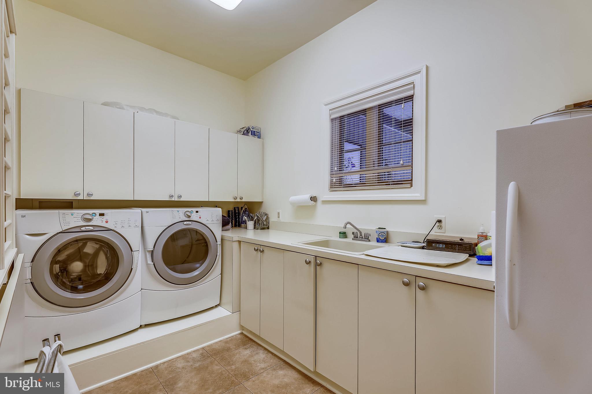 101 Taplow Road Baltimore, MD 21210 - Photo 20 of 59 a utility room with cabinets dryer and washer