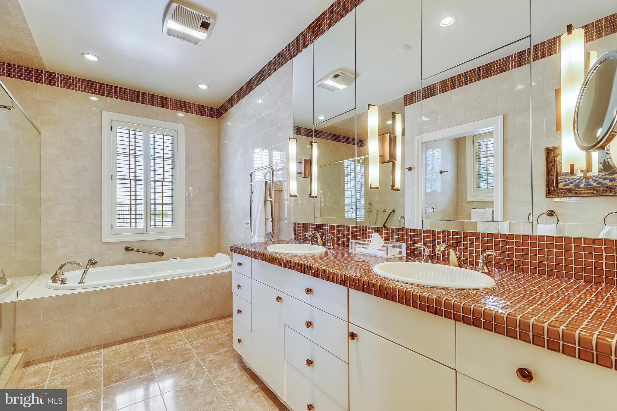 101 Taplow Road Baltimore, MD 21210 - Photo 28 of 59 a bathroom with a tub double sink and mirror