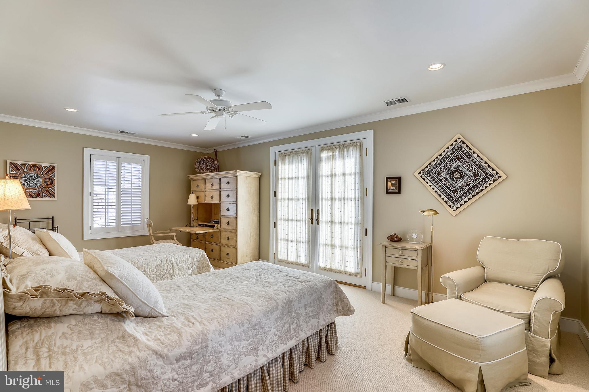 101 Taplow Road Baltimore, MD 21210 - Photo 37 of 59 a spacious bedroom with a bed a couch and large windows