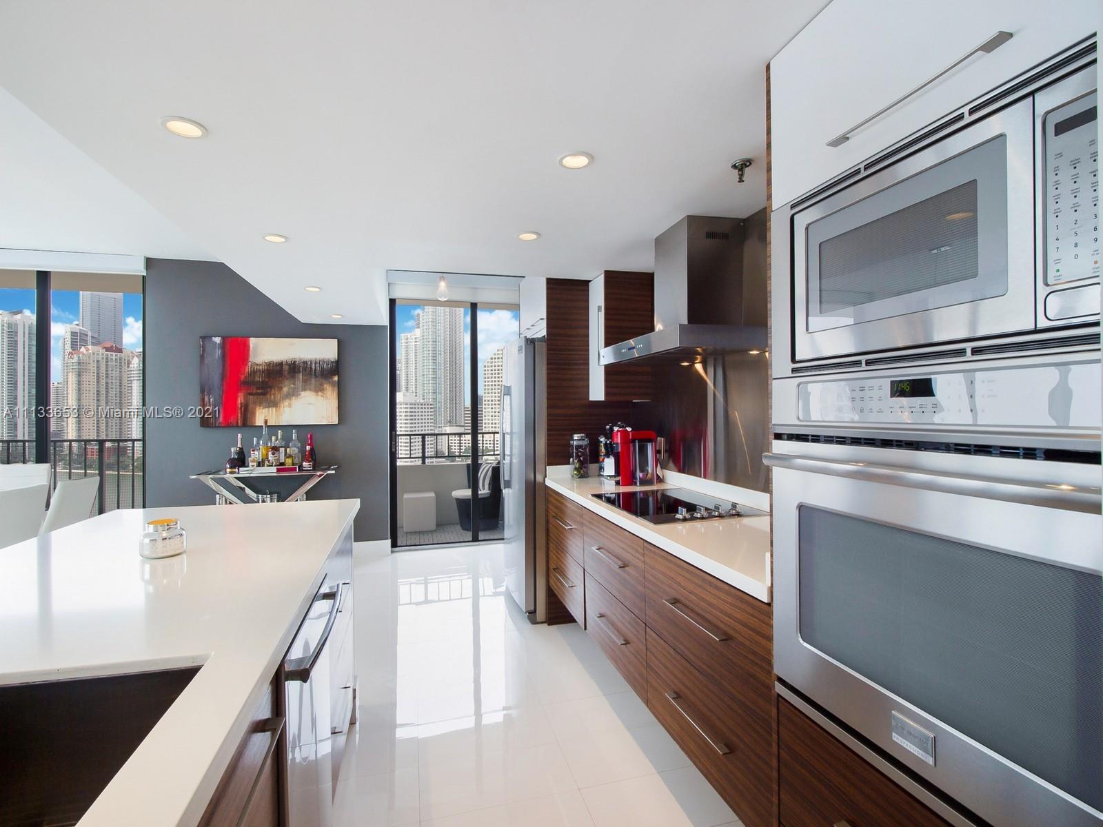 520 Brickell Key Drive, Unit A1815 Miami, FL 33131 - Photo 11 of 34 a kitchen with stainless steel appliances granite countertop a stove and cabinets