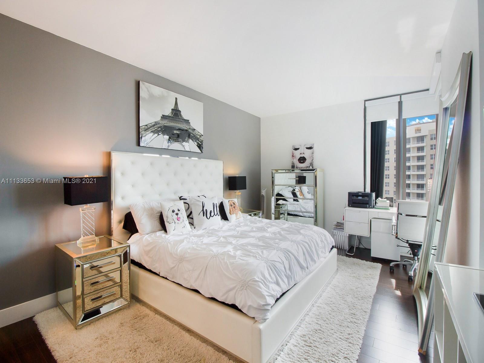 520 Brickell Key Drive, Unit A1815 Miami, FL 33131 - Photo 12 of 34 a bedroom with a bed and a table in it