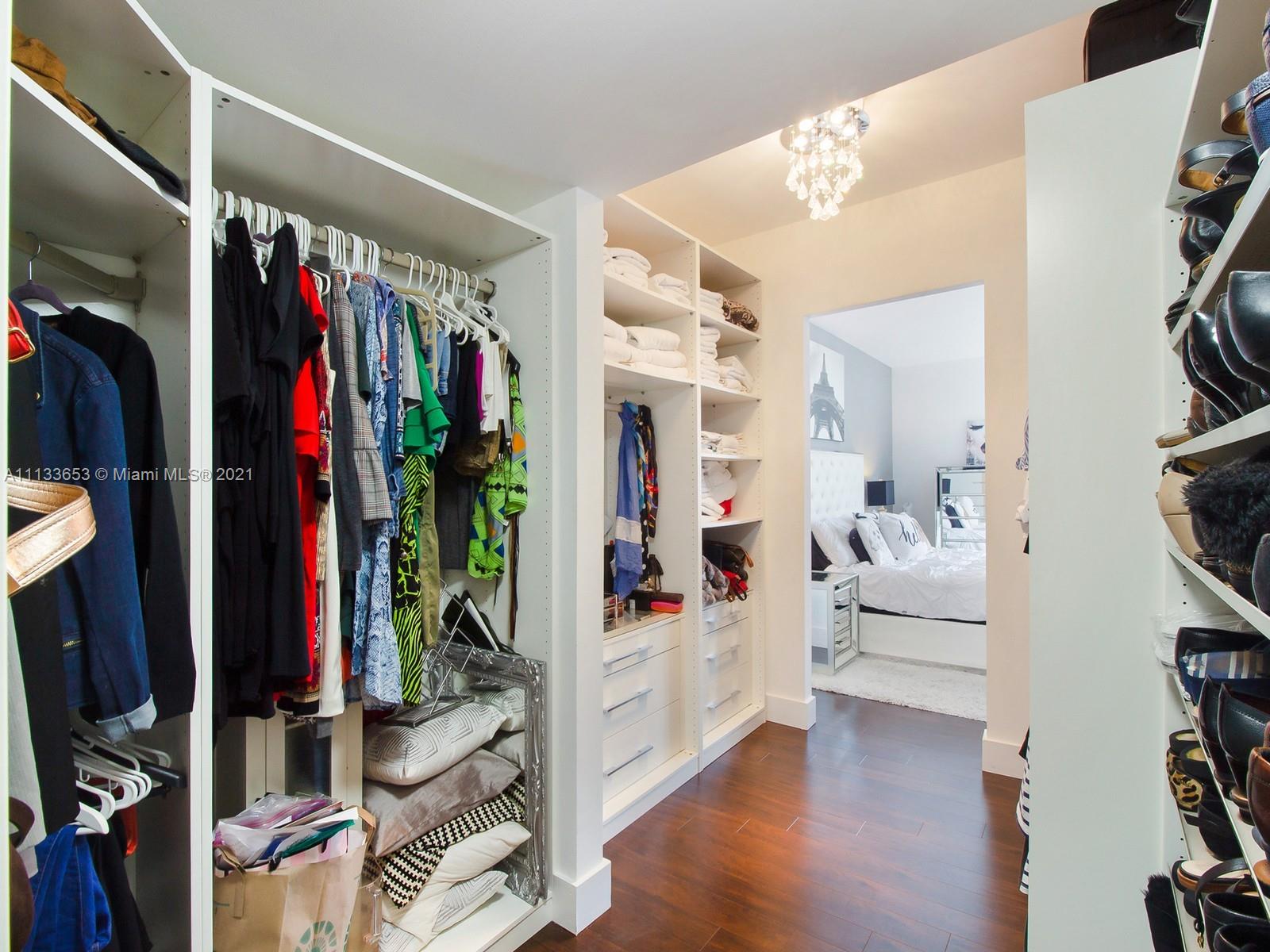 520 Brickell Key Drive, Unit A1815 Miami, FL 33131 - Photo 13 of 34 a view of walk in closet with clothes and shoes