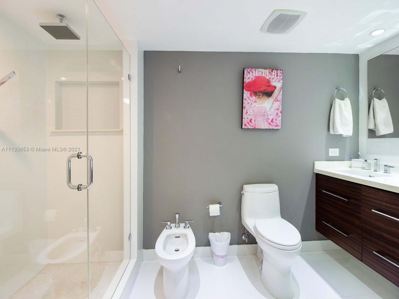 520 Brickell Key Drive, Unit A1815 Miami, FL 33131 - Photo 14 of 34 a bathroom with a toilet sink vanity and shower