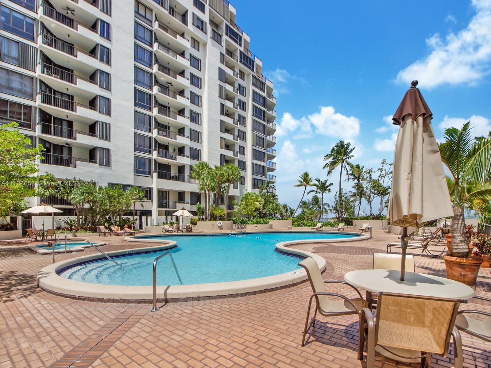 520 Brickell Key Drive, Unit A1815 Miami, FL 33131 - Photo 17 of 34 a view of a swimming pool with a lounge chairs