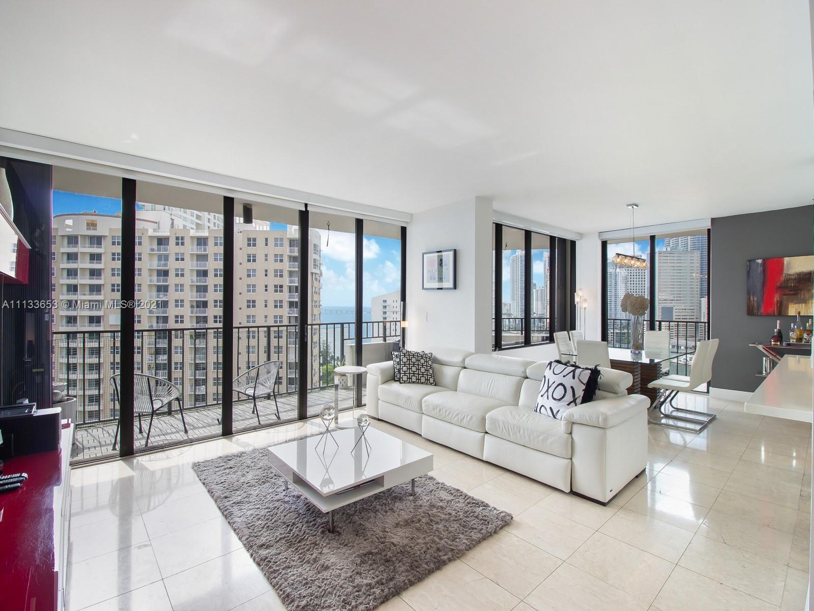 520 Brickell Key Drive, Unit A1815 Miami, FL 33131 - Photo 6 of 34 a living room with furniture and a large window
