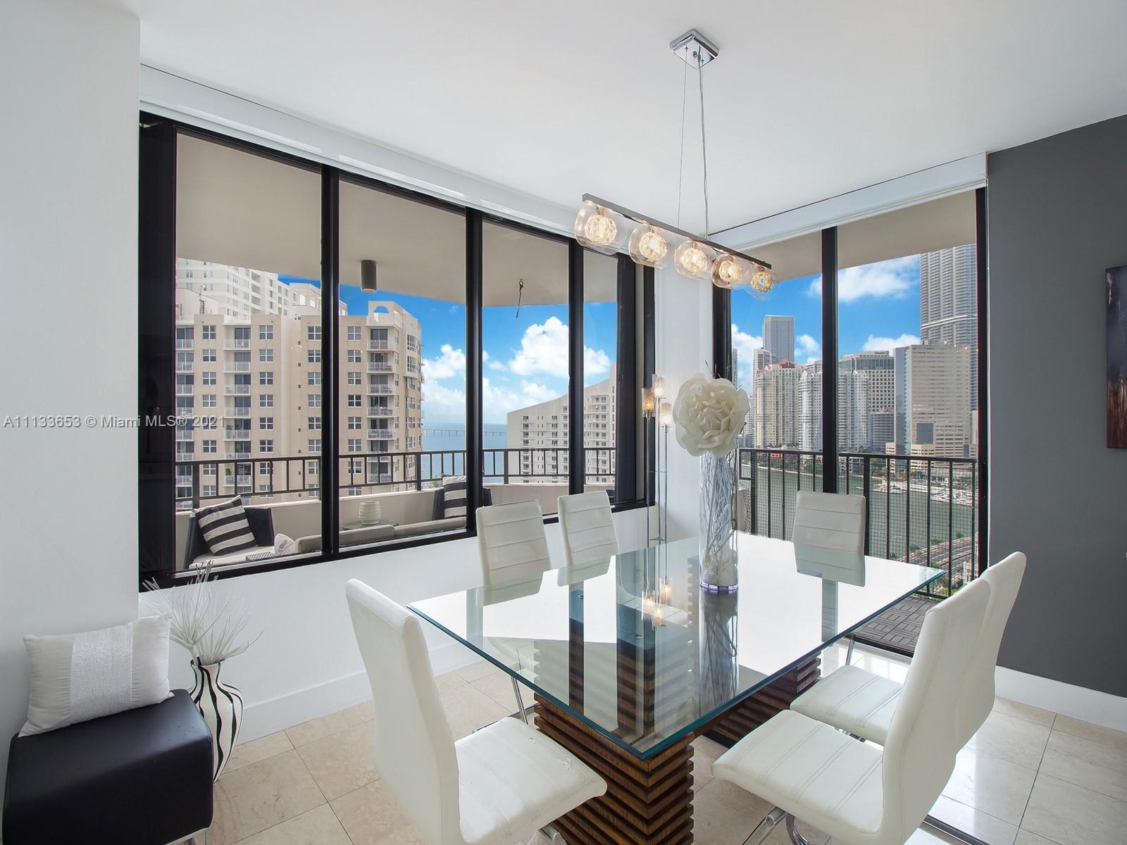 520 Brickell Key Drive, Unit A1815 Miami, FL 33131 - Photo 7 of 34 a dining room with furniture and a floor to ceiling window