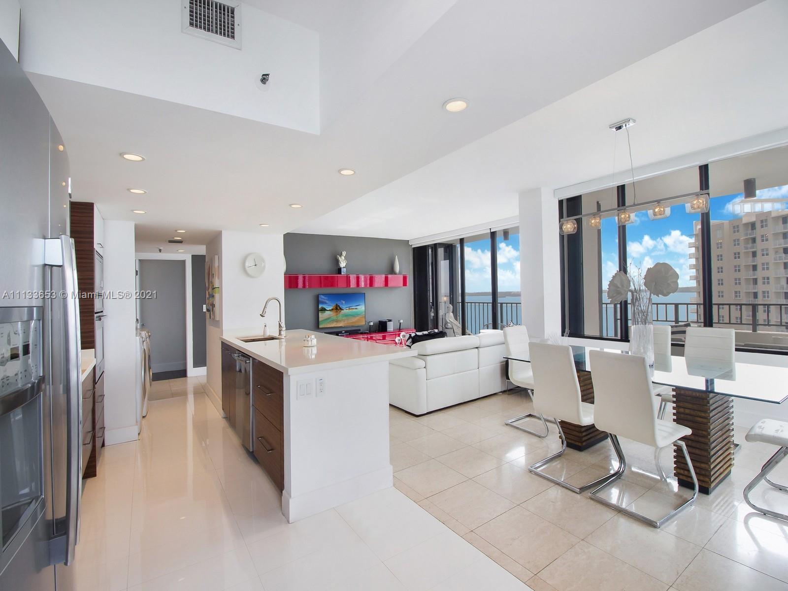 520 Brickell Key Drive, Unit A1815 Miami, FL 33131 - Photo 8 of 34 a living room with furniture and a flat screen tv