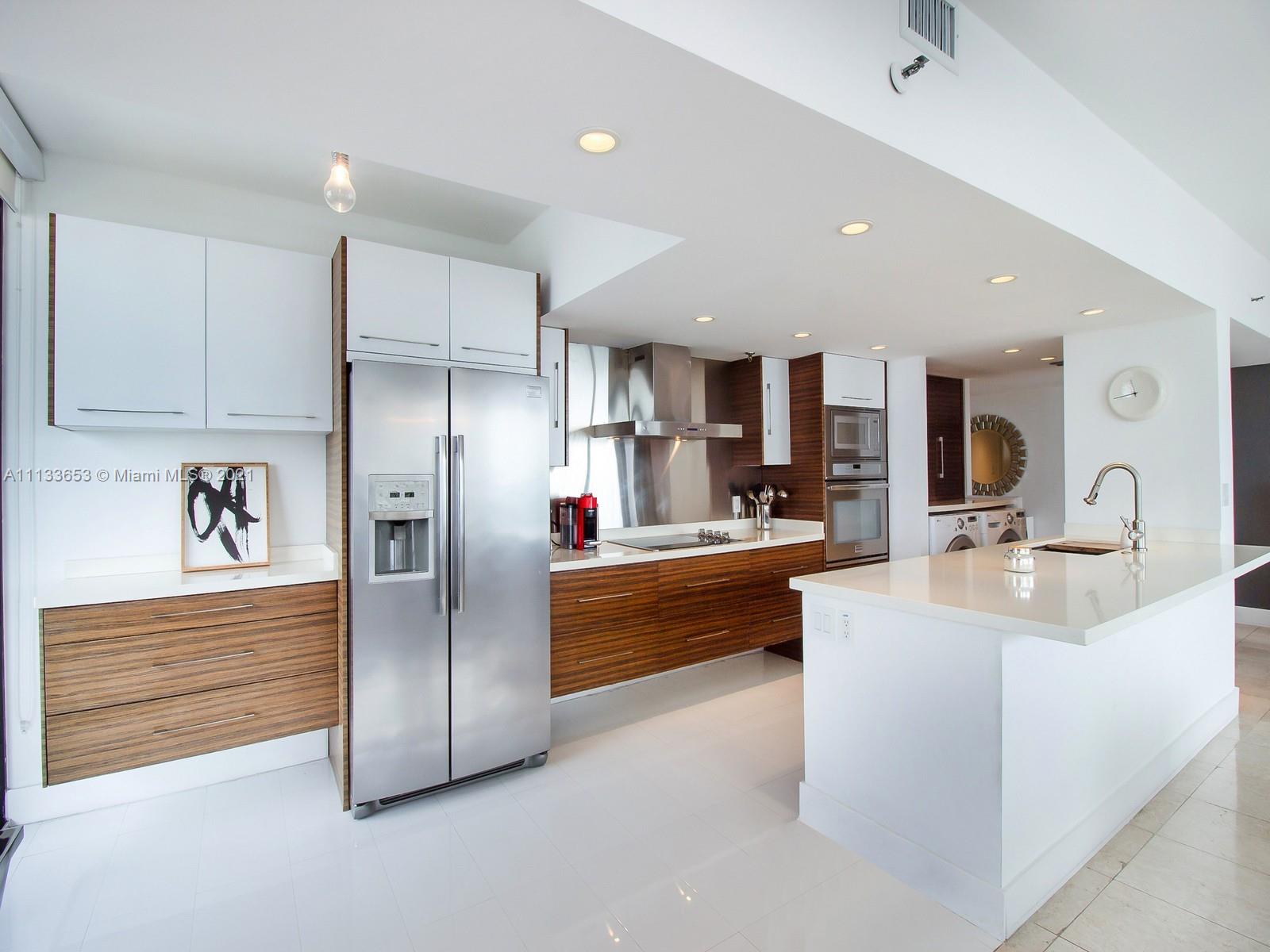 520 Brickell Key Drive, Unit A1815 Miami, FL 33131 - Photo 9 of 34 a kitchen with stainless steel appliances a refrigerator and a sink