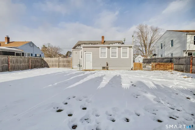 a view of a house with a snow on the road