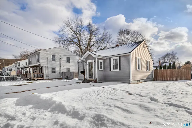 a view of a house with a snow in the yard
