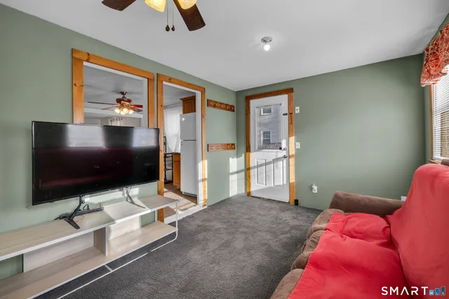 a living room with projector and a flat screen tv