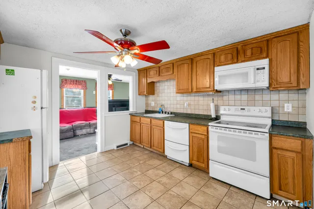 a kitchen with stainless steel appliances granite countertop a stove sink and cabinets