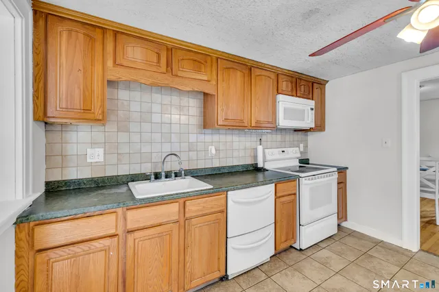 a kitchen with stainless steel appliances granite countertop a sink and cabinets