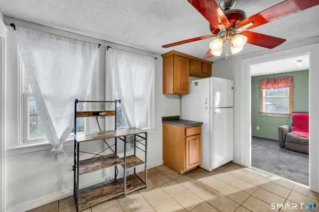 a kitchen with stainless steel appliances a refrigerator and a chandelier