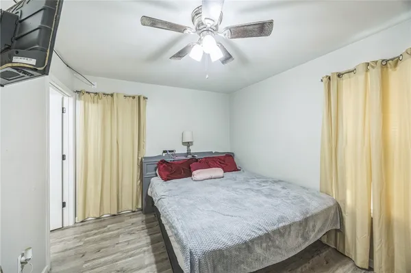 a bedroom with a large bed and a chandelier