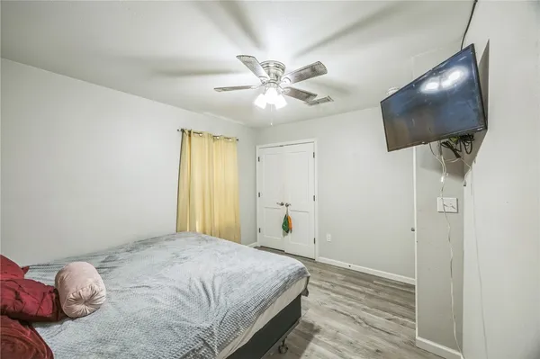 a bedroom with a bed and a flat screen tv