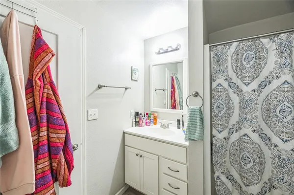 a bathroom with a sink and a walk in closet