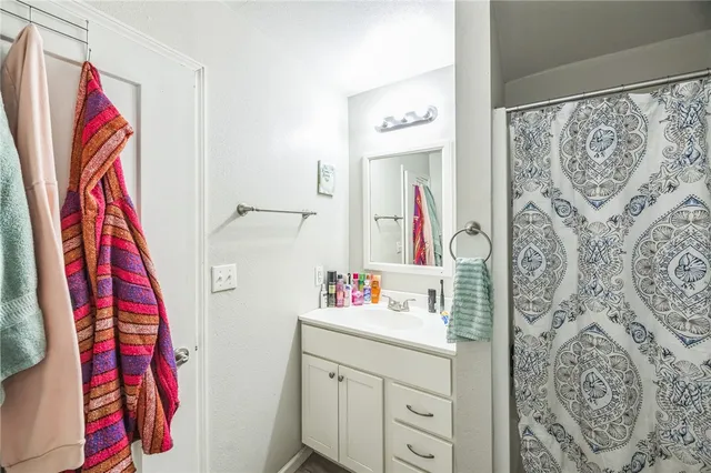 a bathroom with a sink and a walk in closet