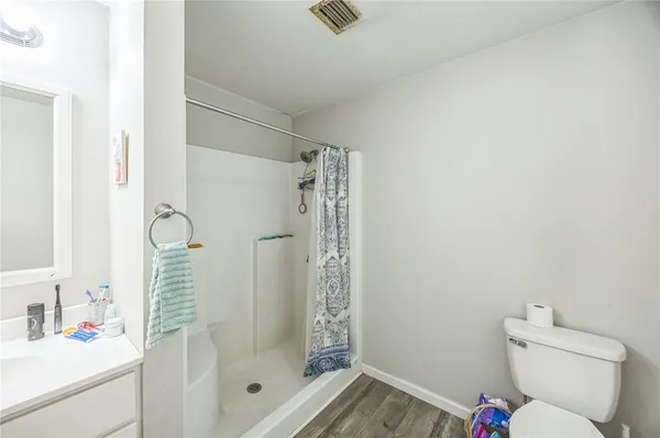 a bathroom with a shower toilet and a sink