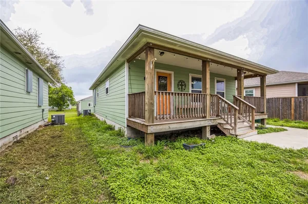 a backyard of a house with a garden and deck