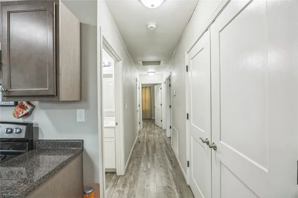 a view of a hallway with wooden floor and staircase