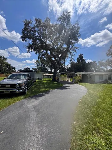 a view of a street with cars parked