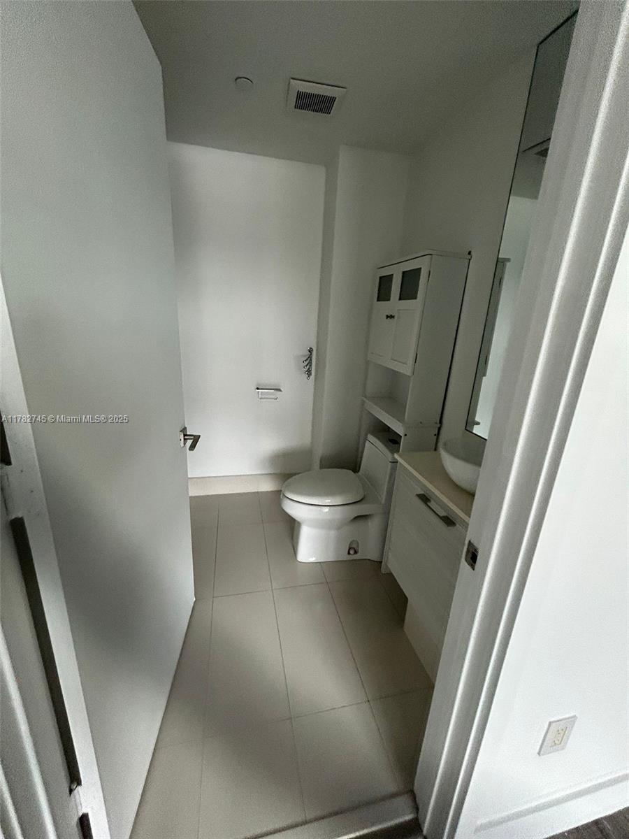 Edgewater Miami, FL 33137 - Photo 7 of 10 a view of a hallway with toilet