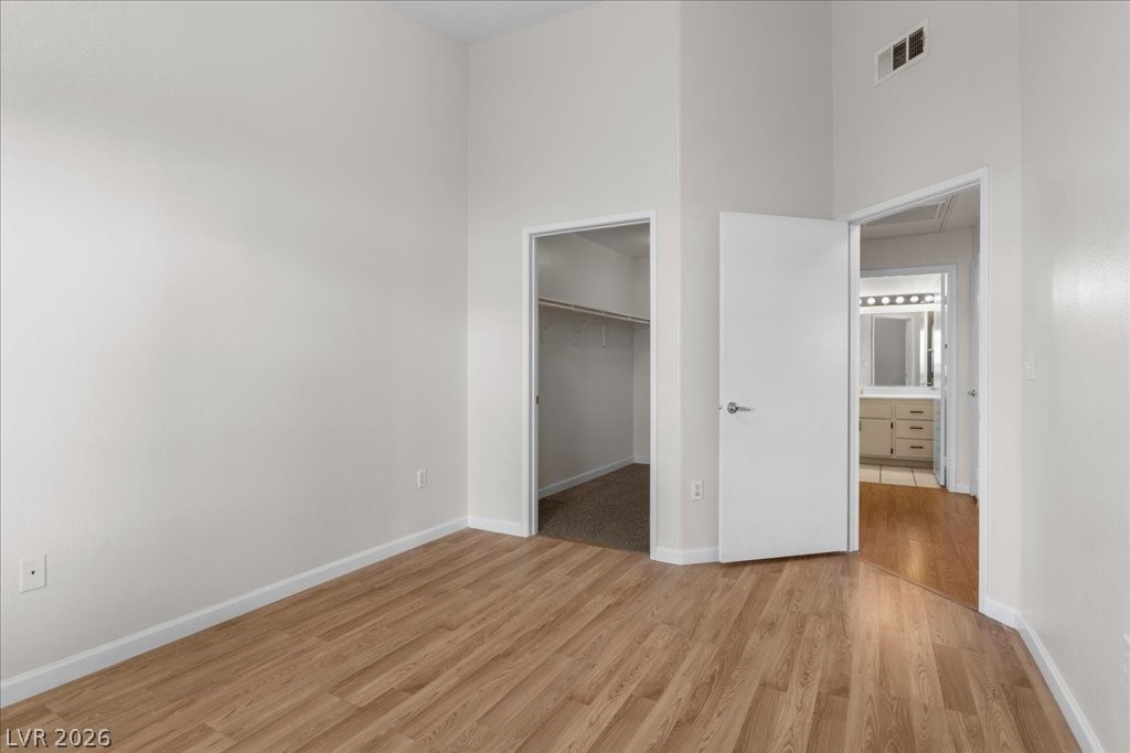 1881 West Alexander Road, Unit 1037 North Las Vegas, NV 89032 - Photo 21 of 31 Laminate Wood flooring in the secondary bedroom with another walk in closet!