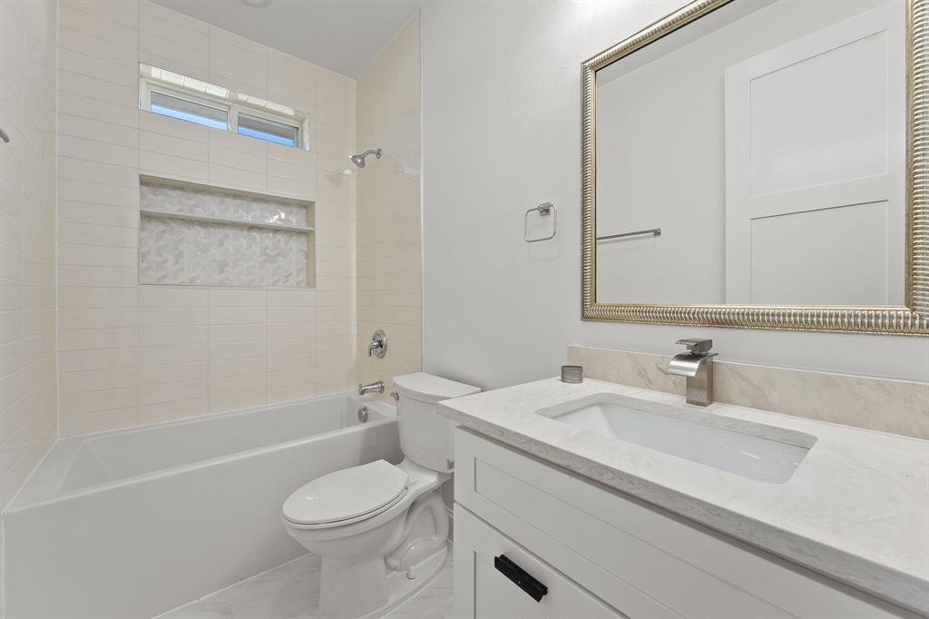 809 South Adelaide Street Terrell, TX 75160 - Photo 9 of 18 a bathroom with a sink a toilet and shower