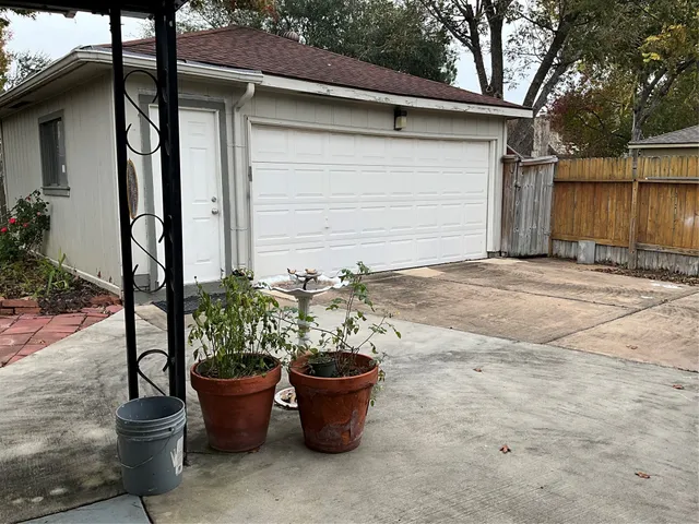a view of a backyard of the house with potted plants