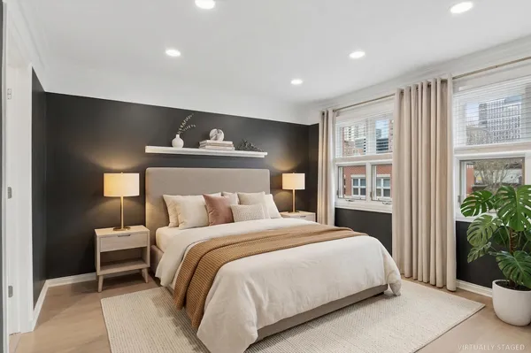 a bedroom with a bed and a potted plant