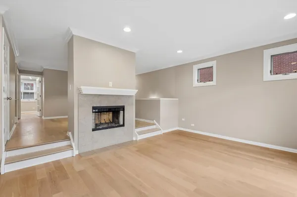 a view of an empty room with a fireplace and a window