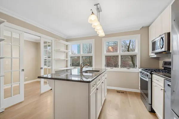 a kitchen with stainless steel appliances granite countertop a stove and a sink